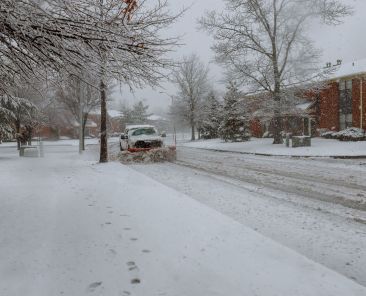 Snowplow removing snow from city road Snowplow trucks removing snow on the road street