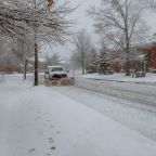 Snowplow removing snow from city road Snowplow trucks removing snow on the road street